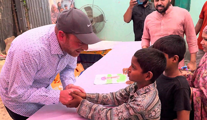 SAM handshaking with kids of Shapla Foundation in the Mohakhali Slum in Bangladesh