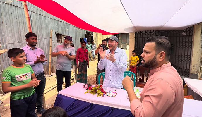 Sam clapping with happy face infront of the kids of Shapla Foundation in the Mohakhali slum